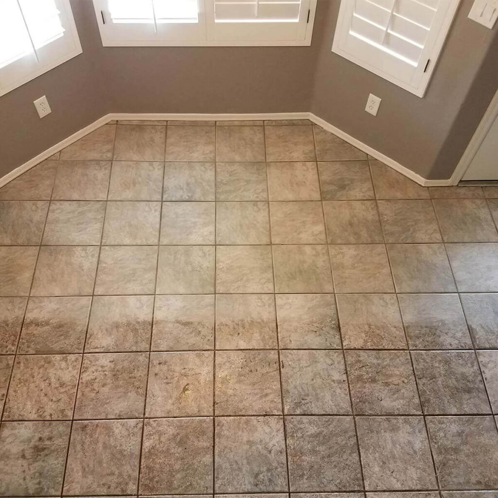 Sea Breeze A corner of a room with beige tiled flooring, gray walls, and white shuttered windows, freshly brightened by meticulous window cleaning. Floor And Window Cleaning